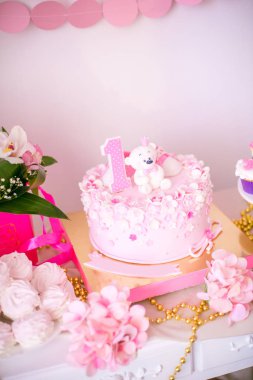 Çok güzel lezzetli şeker pembe ve altın renkleri 1 doğum gününde küçük bir prenses için. Çocuk Parti balonları çiçek ve tatlılar ile dekore edilmiş