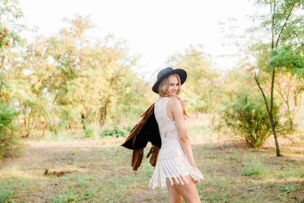 美丽的年轻女孩 金发碧眼 穿着麂皮绒夹克 在乡下的一个阳光明媚的秋日微笑的黑色毛毡帽 — 图库照片
