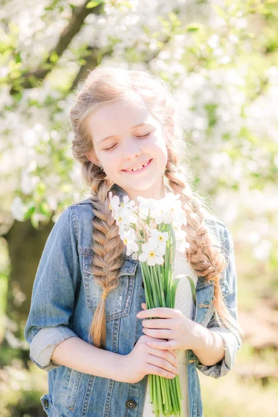 Cute Girl Blond Hair White Sundress Spring Lush Garden Daffodils — Zdjęcie stockowe