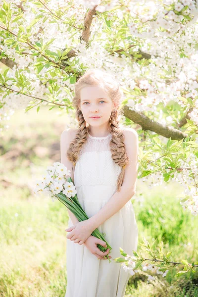 Cute Girl Blond Hair White Sundress Spring Lush Garden Daffodils — Stockfoto