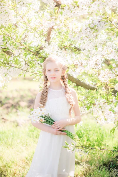 Cute Girl Blond Hair White Sundress Spring Lush Garden Daffodils — Stockfoto
