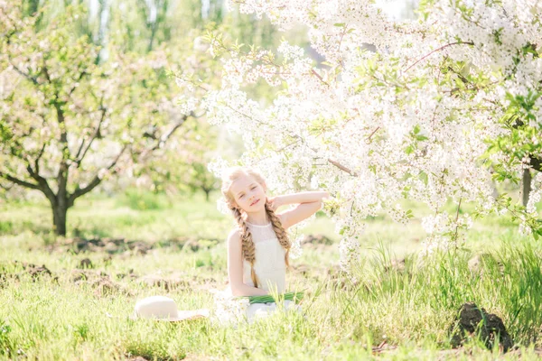 Cute Girl Blond Hair White Sundress Spring Lush Garden Daffodils — Zdjęcie stockowe