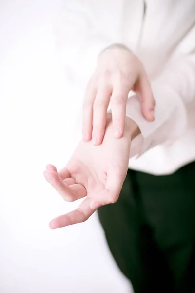 Closeup image of beautiful woman\'s hands with light manicure on the nails. Cream for hands, manicure and beauty treatment. Elegant and graceful hands with slender graceful fingers. - Image