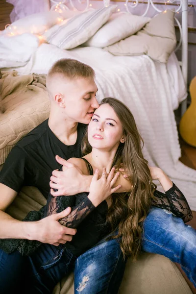 Neşeli genç sevgi dolu çift aşk - görüntü ifade ederken yatak odasında oturmuş