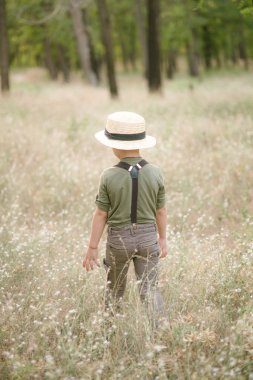 Yaz aylarında parkta bir hasır şapkalı küçük çocuk gün batımı