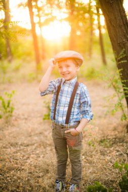 Yaz aylarında parkta bir şapkalı küçük çocuk gün batımı