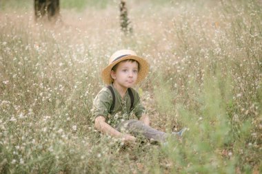Yaz aylarında parkta bir hasır şapkalı küçük çocuk gün batımı
