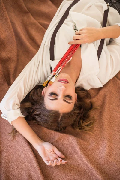 Attractive Girl Artist Dark Hair Brushes Hand Lies Floor Studio — Stock Photo, Image