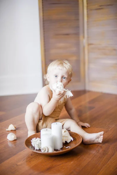Little Cute Baby Blond Curly Hair Wooden Table Shells Candles — Stock Photo, Image