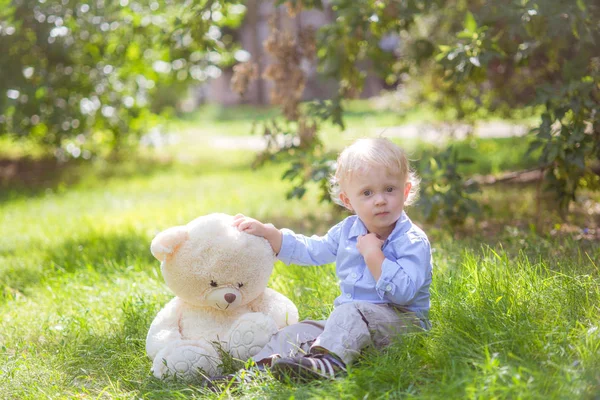 Little Boy Blond Hair Playing Teddy Bear Green Grass Summer — Stock Photo, Image