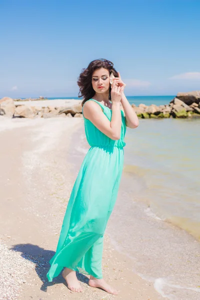 Young girl on summer beach with shell — Stock Photo, Image