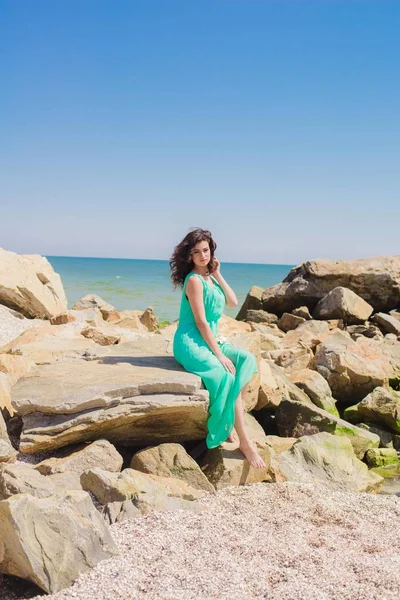 Young beautiful girl in a long dress on the beach — Stock Photo, Image