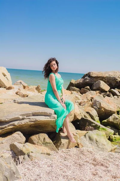 Young beautiful girl in a long dress on the beach — Stock Photo, Image