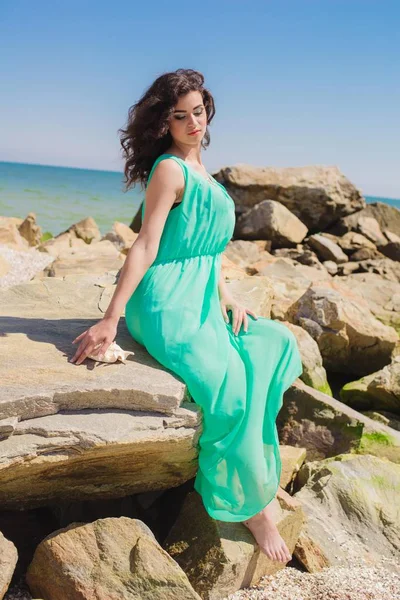 Young beautiful girl in a long dress on the beach — Stock Photo, Image