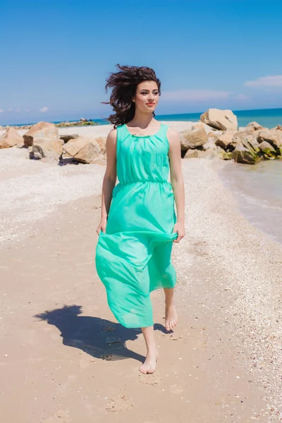 Young beautiful girl in a long dress on the beach — Stock Photo, Image