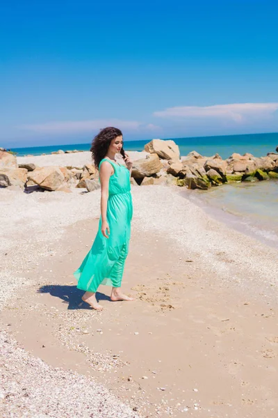 Young beautiful girl in a long dress on the beach — Stock Photo, Image