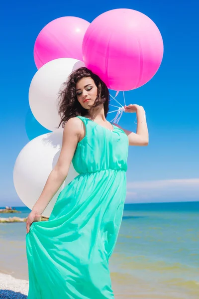 Belle fille sur la plage avec des ballons colorés — Photo
