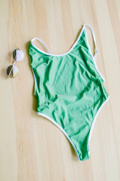 Bright Trendy Bikinis Wooden Background Sunglasses Fashionable Beachwear Accessories — Stock Photo, Image