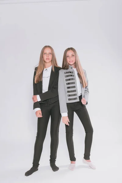 Twee Leuke Meisjes Schoolmeisjes Een Trendy Schooluniform Een Witte Achtergrond — Stockfoto