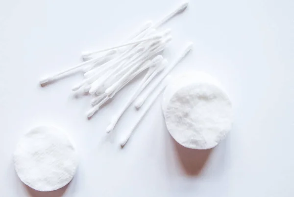 Cotton buds and cotton pads on a white background