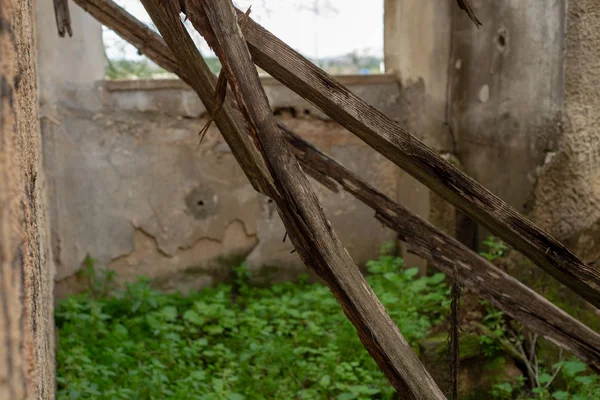 Burned wood sticks fold down in the abandoned house