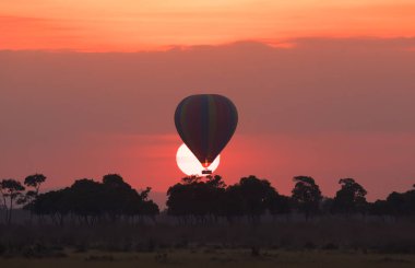 Güzel gün batımı arka plan üzerinde büyük çizgili balon