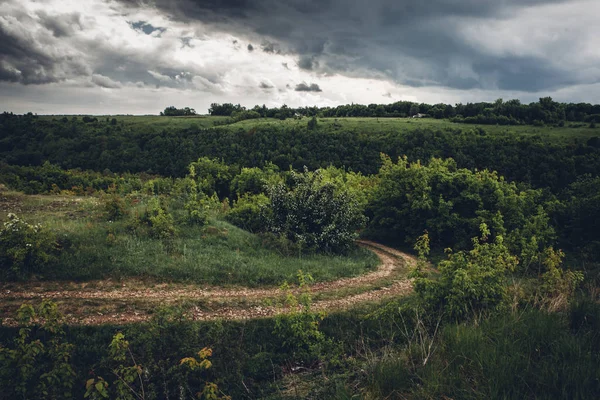 road and rainy sky by day