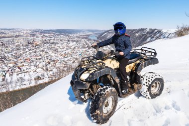 Travel in the winter on the ATV. Beautiful winter nature. clipart