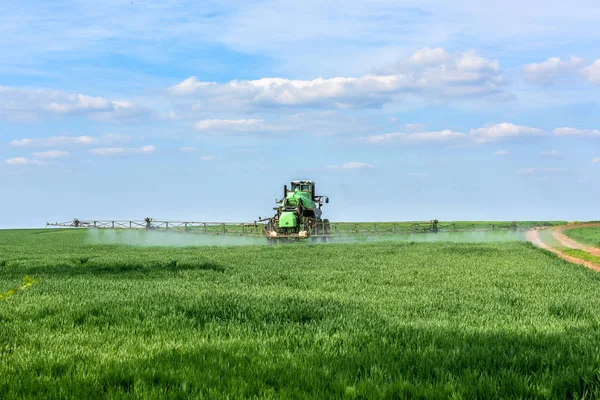 Tractor Fertilizes Wheat Shoots — Stock Photo, Image