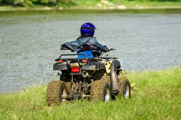 The boy is traveling on an ATV. — Stock Photo, Image