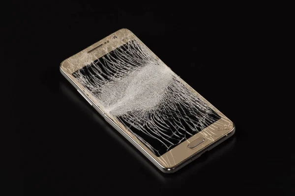 Smartphone with a broken screen on an isolated background