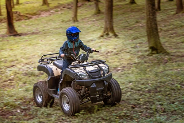 The boy is traveling on an ATV. — Stock Photo, Image