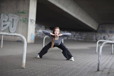 Kaldırımda gerçekleştirme kadın sokak dansçısı. Tam boy. 