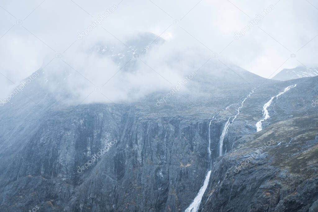 Mountaintop in Norway with cloud cover and Stigfossen waterfall. 