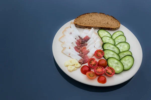 Sliced salted lard served with cucumber, tomato and bread. Traditional Russian snack. Homemade food. Healthy food. Organic ingredients copy space — Stock Image Sliced Salted Lard Served Cucumber Tomato Bread Traditional Russian Snack Royalty Free Stock Images