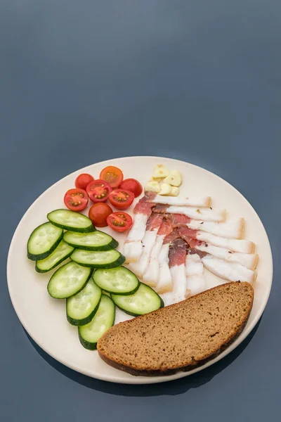 Sliced salted lard served with cucumber, tomato and bread. Traditional Russian snack. Homemade food. Healthy food. Organic ingredients. copy space — Stock Image Sliced Salted Lard Served Cucumber Tomato Bread Traditional Russian Snack Royalty Free Stock Photos