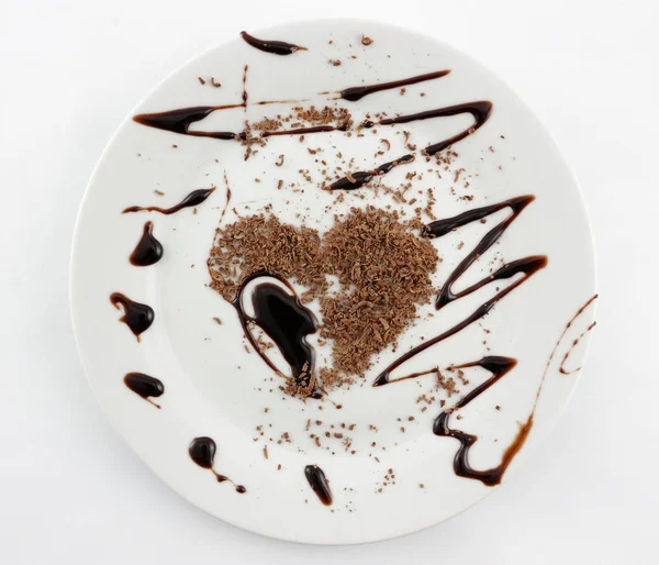 plate with grated and liquid chocolated in heart shape