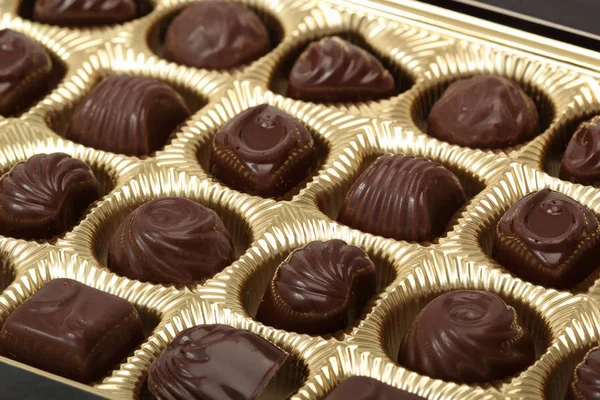 dark chocolate candies in box, close up shot