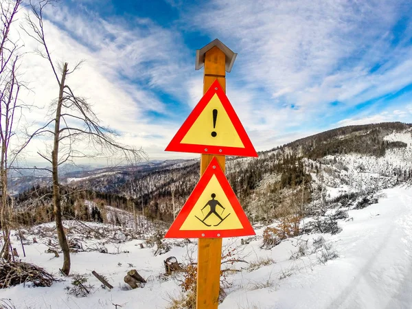 Ski warning sign pole on Wielki Rogacz Mount. Beskids Mountains in winter, Poland.