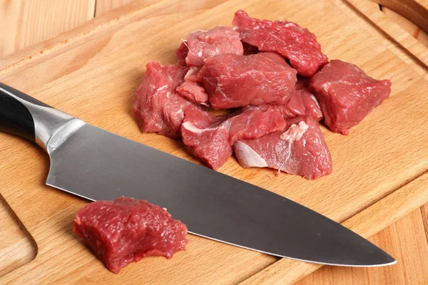 Diced beef casserole steak on cutting board