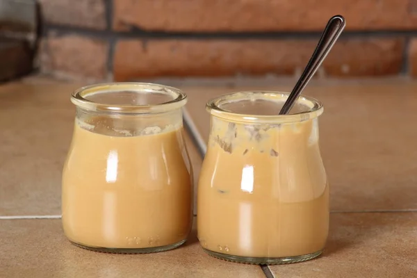 Open bottle with milk pudding dessert