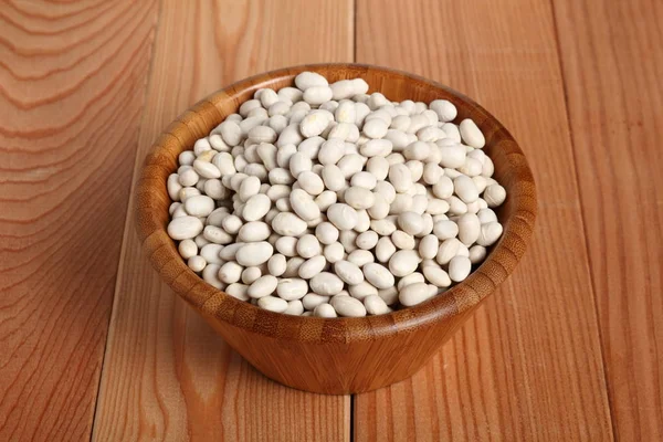 Navy beans in wooden bowl