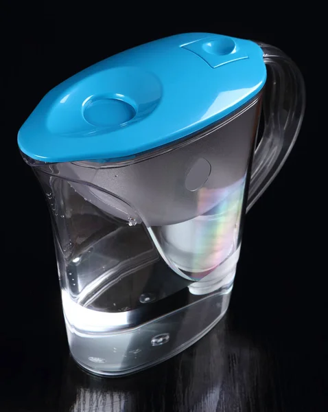 Water filter jug at black background