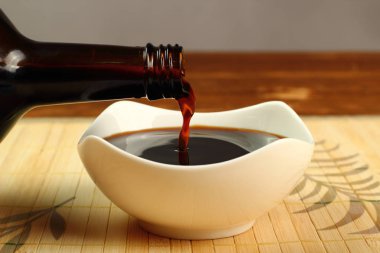 Pouring Soy Sauce into bowl clipart