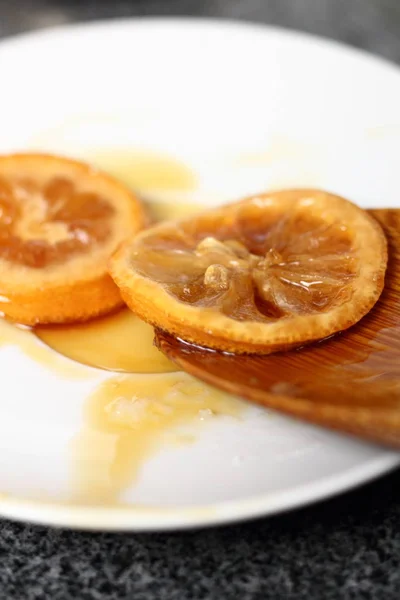 Candied in Treacle Syrup Lemon Slices on plate
