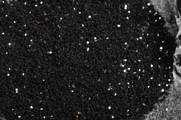 Background of black cumin seeds. Directly Above.