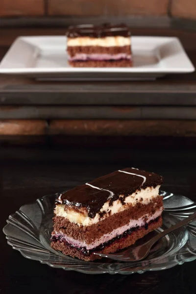 Layer cake with fruit and cream fillings decorated chocolate icing