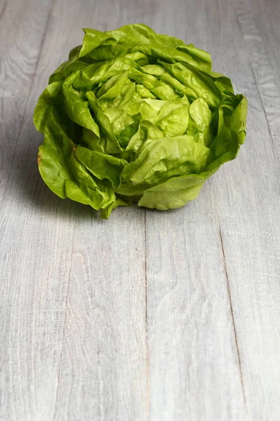 Butter lettuce on wooden background