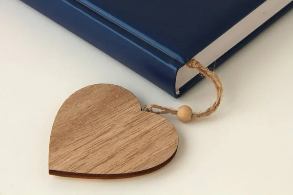 Blue book with a heart bookmark on a white background