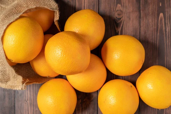 Overhead shot of oranges on wooden table